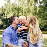 Parents kissing happy son